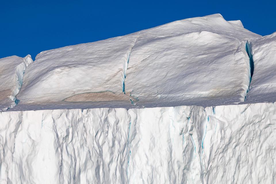 Cracks in an iceberg floating in Disko Bay, Ilulissat, western Greenland, on June 30, 2022.