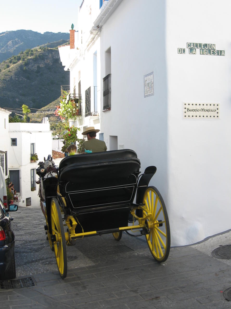 This June 1, 2013 photo shows wedding guests leaving a church by horse carriage in Frigiliana, Spain. Frigiliana is one of Spain's "pueblos blancos," or white villages that sit high above the Mediterranean coast. (AP Photo/Giovanna Dell’Orto)