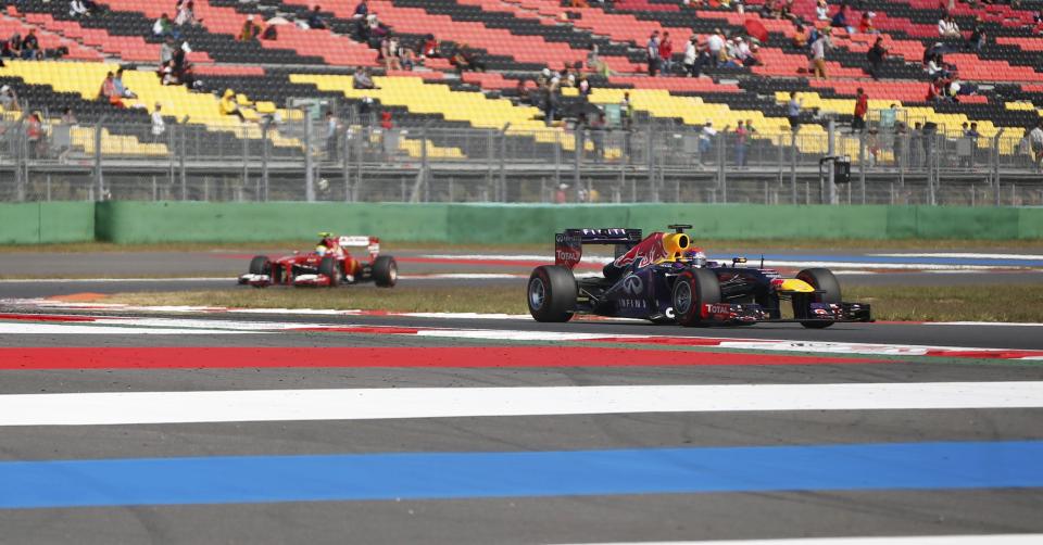 Red Bull Formula One driver Sebastian Vettel of Germany (R) races ahead of Ferrari Formula One driver Felipe Massa of Brazil in front of near empty stands during the third practice session of the Korean F1 Grand Prix at the Korea International Circuit in Yeongam, October 5, 2013. REUTERS/Kim Hong-Ji (SOUTH KOREA - Tags: SPORT MOTORSPORT F1)