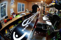 Heinz Haemmerle, or "Magic Heinzi" as US skier Lindsey Vonn calls her Austrian-born ski technician, puts on wax on a pair of skis of the world's most successful skiing women in his tiny waxing container at the Winter Olympics 2018 in Pyeongchang, South Korea February 19, 2018. Picture taken February 19, 2018. REUTERS/Leonhard Foeger