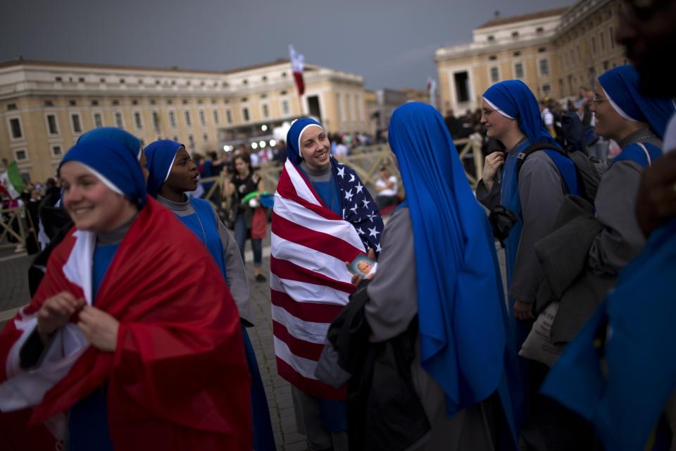 Nuns gather in St. Peter's Square at the Vatican, Saturday, April 26, 2014. Pilgrims and faithful are gathering in Rome to attend Sunday's ceremony at the Vatican where Pope Francis will elevate in a solemn ceremony John XXIII and John Paul II to sainthood. (AP Photo/Emilio Morenatti)