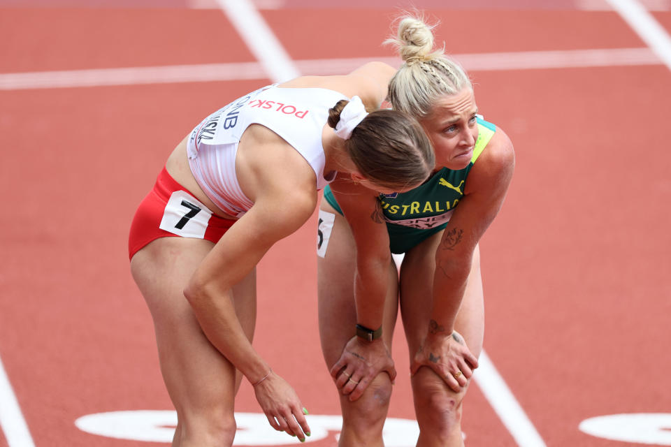 Liz Clay, pictured here being consoled by Pia Skrzyszowska after falling in the 100m hurdles heats.