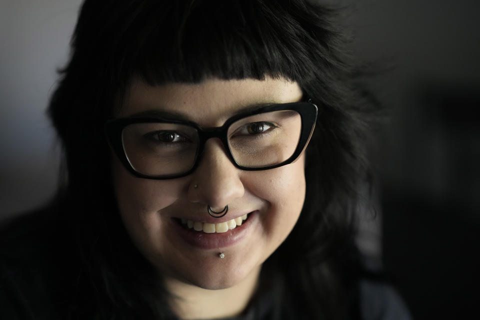 Beka Favela sits for a portrait at her Westmont, Ill., apartment, Tuesday, June 20, 2023. After a payment pause that has lasted more than three years, more than 40 million student loan borrowers will be on the hook for payments starting in the fall. (AP Photo/Charles Rex Arbogast)