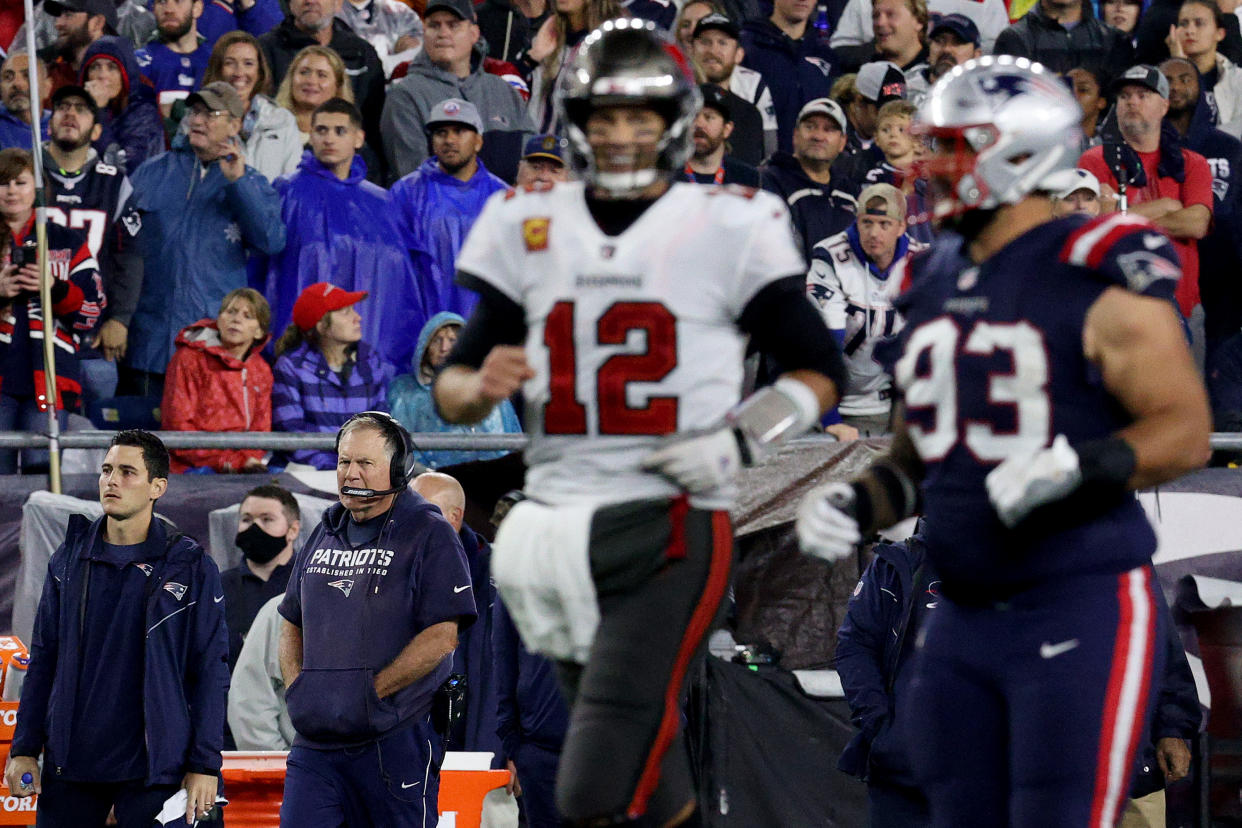 FOXBOROUGH, MASSACHUSETTS - OCTOBER 03: Head coach Bill Belichick of the New England Patriots looks on as Tom Brady #12 of the Tampa Bay Buccaneers runs past during the fourth quarter in the game at Gillette Stadium on October 03, 2021 in Foxborough, Massachusetts. (Photo by Maddie Meyer/Getty Images)