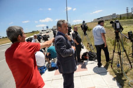 Journalists wait outside the prison where three of the five men cleared of gang rape of a teenager and convicted of a lesser crime of sexual abuse are due to leave jail after being granted provisional release in Pamplona, Spain, June 22, 2018. REUTERS/Pablo Lasaosa