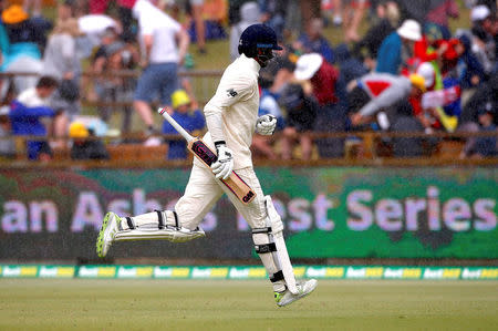 Cricket - Australia v England - Ashes test match - WACA Ground, Perth, Australia, December 17, 2017 - England's Dawid Malan runs off the ground as rain delays play during the fourth day of the third Ashes cricket test match. REUTERS/David Gray