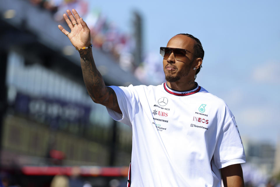 Mercedes driver Lewis Hamilton of Britain waves to fans as he arrives for the driver's parade ahead of the Australian Formula One Grand Prix at Albert Park in Melbourne, Sunday, April 2, 2023. (AP Photo/Asanka Brendon Ratnayake)