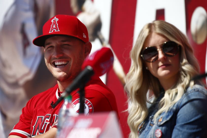 Angels star Mike Trout and his wife Jessica listen to a question during a news conference at Angel Stadium on Sunday.