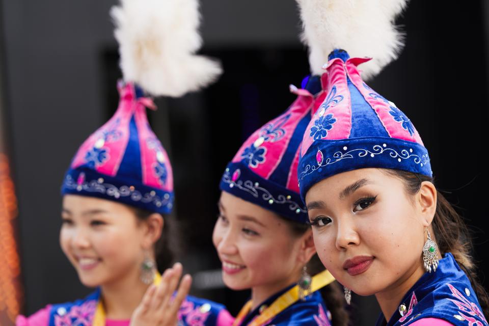 Performers from Kazakhstan's pavilion pose for photographs at Expo 2020, in Dubai, United Arab Emirates, Sunday, Oct. 3, 2021. (AP Photo/Jon Gambrell)