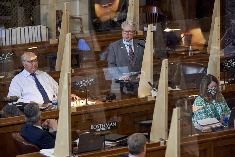 Speaker of the legislature Sen. Jim Scheer of Norfolk, top center, addresses lawmakers in Lincoln, Neb., Monday, July 20, 2020. Nebraska lawmakers resumed their session after a four-month pause triggered by the coronavirus pandemic. They still have major issues to address, including a property tax package and an upgrade of Nebraska's biggest tax incentive program, but all of that may be overshadowed by the pandemic's impact on tax revenue. (AP Photo/Nati Harnik)