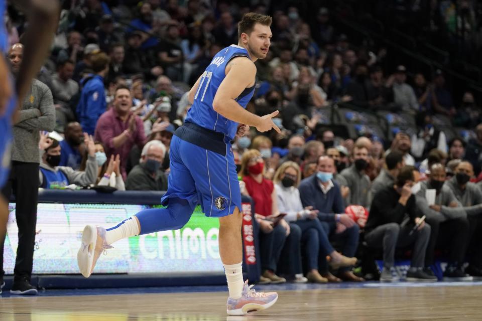 Dallas Mavericks guard Luka Doncic celebrates sinking a three-point basket in the first half of an NBA basketball game against the Cleveland Cavaliers in Dallas, Monday, Nov. 29, 2021. (AP Photo/Tony Gutierrez)