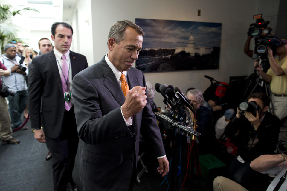 Speaker of the House Rep. John Boehner, R-Ohio, pumps his fist as he walks past reporters after a meeting with House Republicans on Capitol Hill on Wednesday, Oct. 16, 2013 in Washington. (AP Photo/ Evan Vucci)
