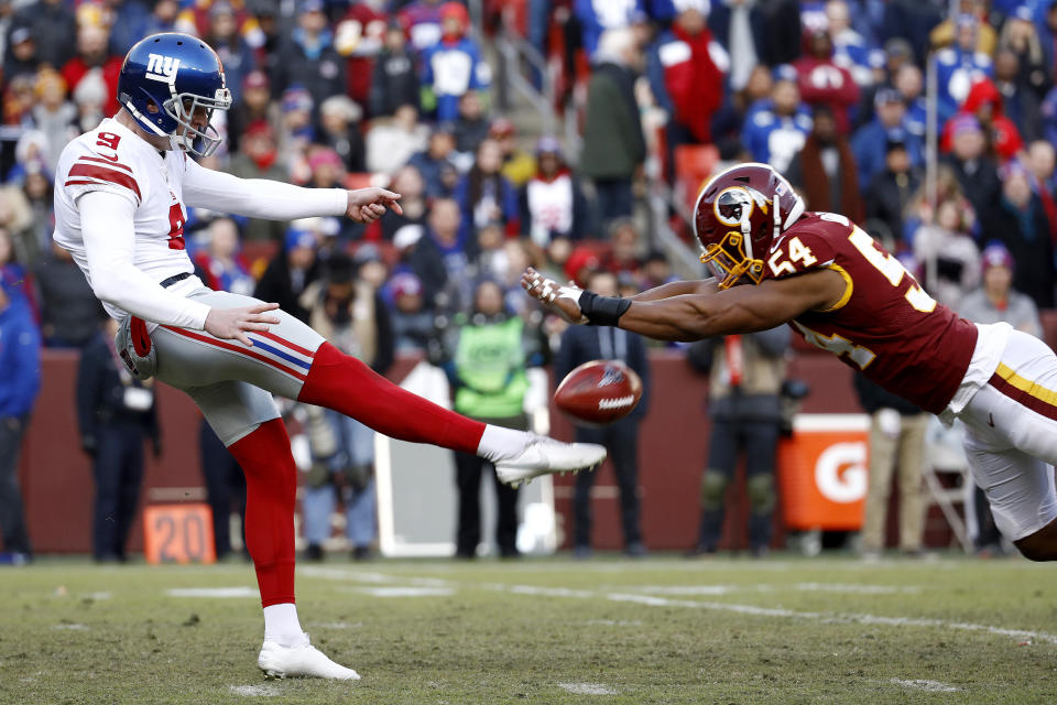 Washington Redskins linebacker Nate Orchard, right, blocks a punt attempt by New York Giants punter Riley Dixon during the second half of an NFL football game, Sunday, Dec. 22, 2019, in Landover, Md. (AP Photo/Patrick Semansky)
