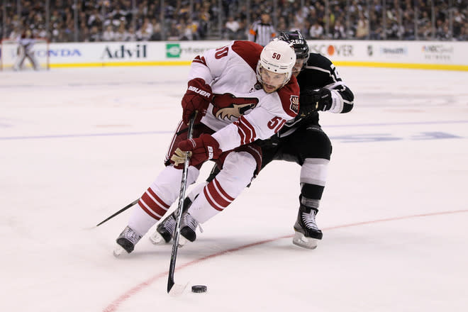   Antoine Vermette #50 Of The Phoenix Coyotes And Slava Voynov #26 Of The Los Angeles Kings Battle For The Puck In The Getty Images