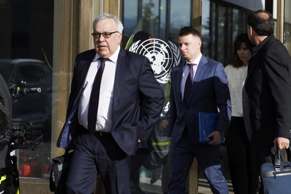 Russia's deputy foreign minister Sergei Vershinin, left, leaves the UN building after talks on the Black Sea grain deal, at the European headquarters of the United Nations in Geneva (AP)