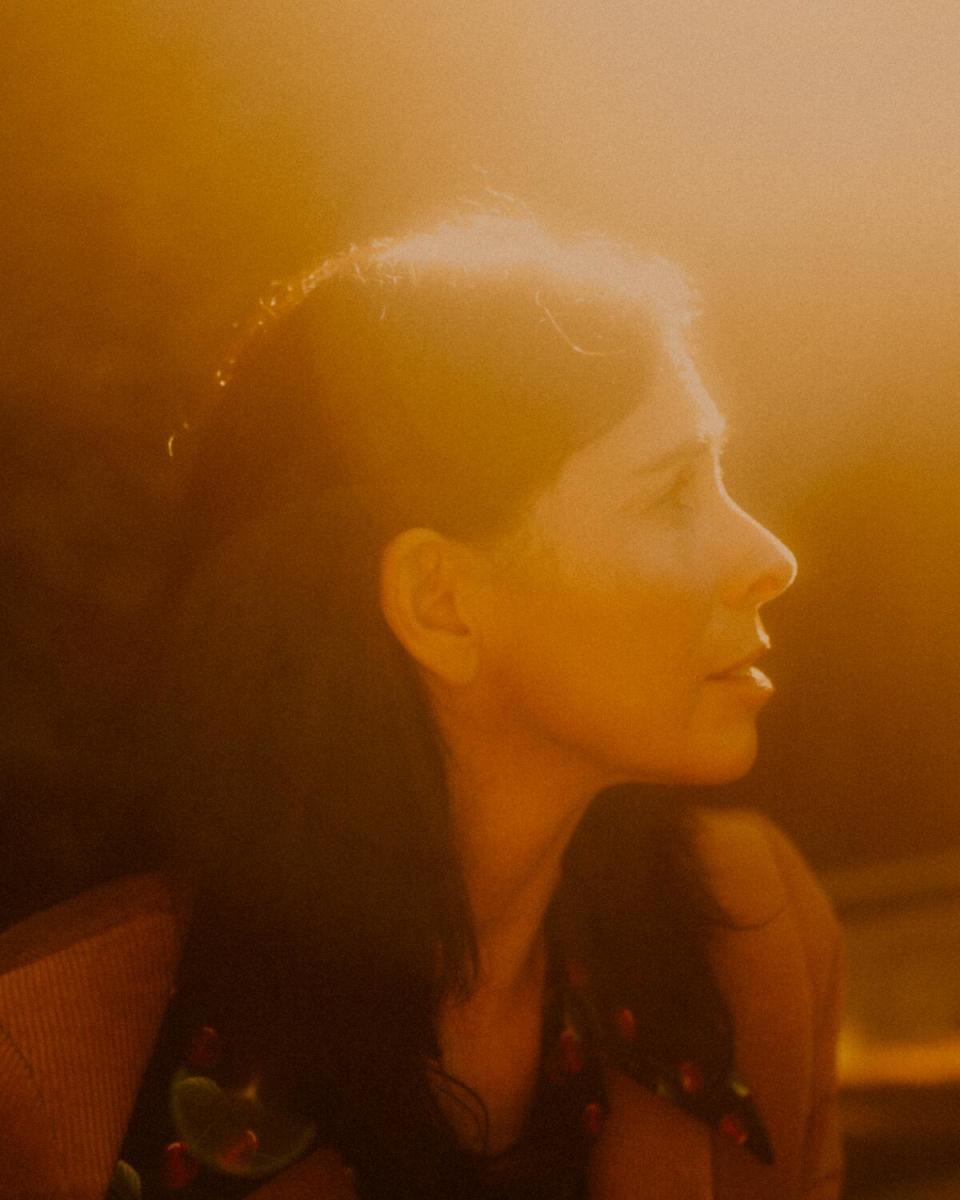 A profile shot of Sarah Silverman cast in golden sunlight.