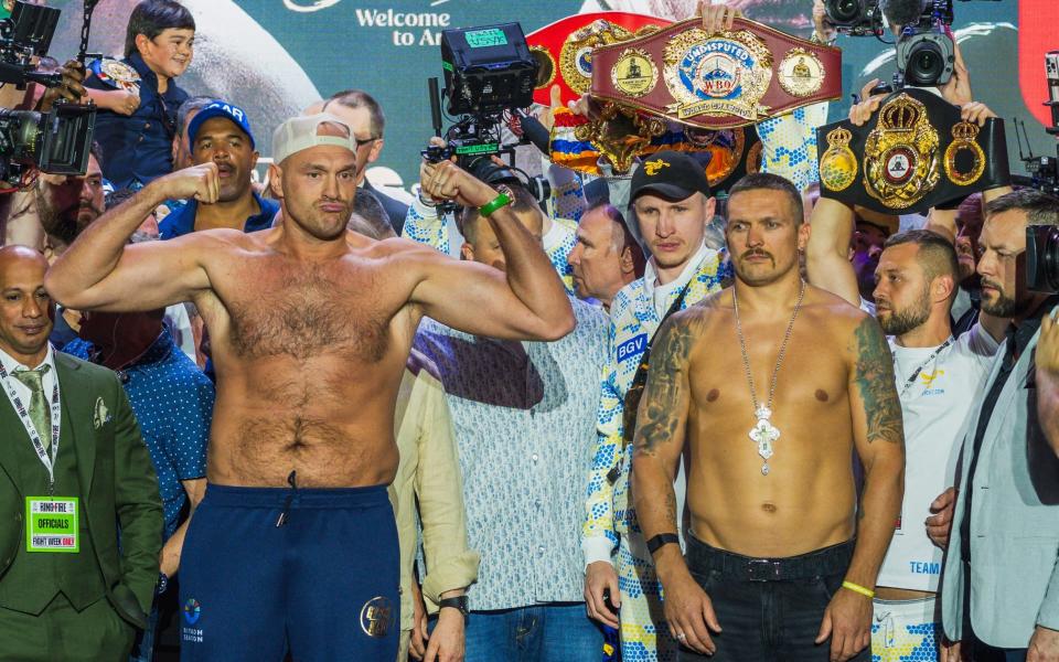 Britain's Tyson Fury (L) and Ukraine's Oleksandr Usyk (R) stand on stage during the official weigh-in on the eve of their heavyweight world boxing championship fight in Riyadh on May 17, 2024