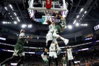 Milwaukee Bucks' Giannis Antetokounmpo dunks over Boston Celtics' Grant Williams during the second half of Game 6 of an NBA basketball Eastern Conference semifinals playoff series Friday, May 13, 2022, in Milwaukee. (AP Photo/Morry Gash)