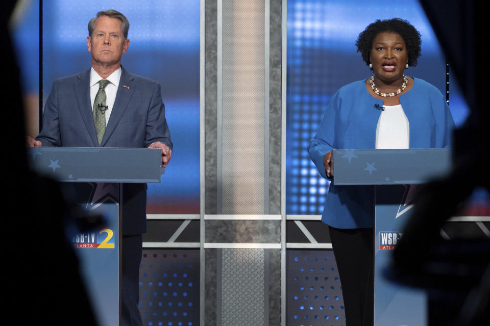 FILE - Republican Georgia Gov. Brian Kemp, left, and Democratic challenger Stacey Abrams face off in a televised debate, in Atlanta, Oct. 30, 2022. Having vanquished both a Donald Trump-backed Republican challenger and Abrams to win reelection, Kemp is looking to expand his influence in his second term, free from the caricature of the gun-toting, pickup-driving, migrant-catching country boy that emerged during his first campaign for governor. (AP Photo/Ben Gray, File)