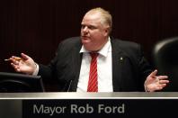 Toronto Mayor Rob Ford attends a special council meeting at City Hall in Toronto November 18, 2013. The Toronto city council may further curb the powers of embattled Mayor Rob Ford on Monday, slashing his office budget and offering his staff a chance to transfer to new jobs. REUTERS/Aaron Harris (CANADA - Tags: POLITICS)