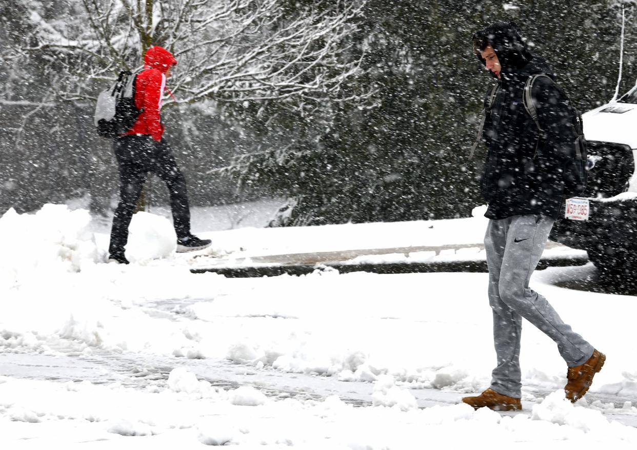 WORCESTER - WPI sophomore Matt Maguire of Abington, right, walks to the campus parking garage as the snow ramps up on Tuesday morning. Classes after noon were canceled.