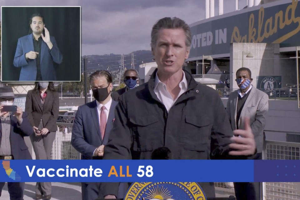 In this photo taken from video, provided by the Office of the Governor, is California Gov. Gavin Newsom speaking during a virtual briefing from the Oakland-Alameda County Coliseum in Oakland, Calif., on Wednesday, Feb. 3, 2021. California is joining with the federal government to open two new vaccination centers as test areas for new President Joseph Biden's effort to create 100 mass vaccination sites nationwide in 100 days, Newsom said Wednesday. The sites at the Oakland-Alameda Coliseum and California State University, Los Angeles, will be jointly run by the Federal Emergency Management Agency and the Governor's Office of Emergency Services. (Office of the Governor via AP)