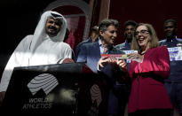 Sheikh Joaan bin Hamad bin Khalifa Al Thani, IAAF President Sebastian Coe hands over a ceremonial baton to Oregon Governor Kate Brown pose at the closing ceremony for the World Athletics Championships in Doha, Qatar, Sunday, Oct. 6, 2019. (AP Photo/Morry Gash)