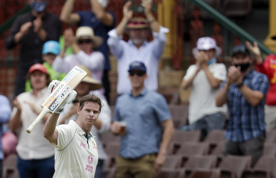 Australia's Steve Smith waves to the crowd as he walks from the field after he was run out 131 runs during play on day two of the third cricket test between India and Australia at the Sydney Cricket Ground, Sydney, Australia, Friday, Jan. 8, 2021. (AP Photo/Rick Rycroft)