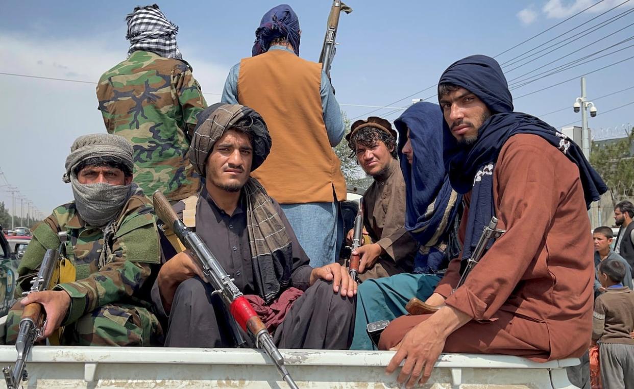 Taliban forces patrol near the entrance gate of Hamid Karzai International Airport, a day after U.S troops withdrew, in Kabul, Afghanistan on August 31, 2021. (REUTERS - image credit)