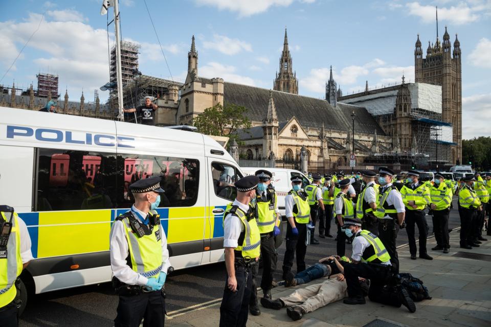 : An Extinction Rebellion demonstrator is held by the police (Getty Images)