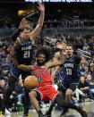 Chicago Bulls guard Coby White (0) falls as he is fouled by Orlando Magic center Moritz Wagner (21) after getting past Orlando Magic guard Cole Anthony (50) during the second half of an NBA basketball game, Sunday, April 7, 2024, in Orlando, Fla. (AP Photo/John Raoux)