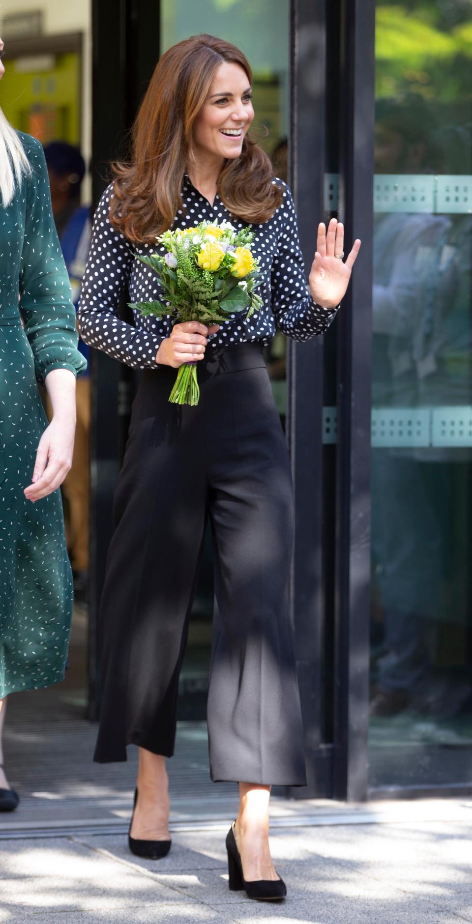 Kate Middleton wears a polka-dot shirt and black Zara pants.