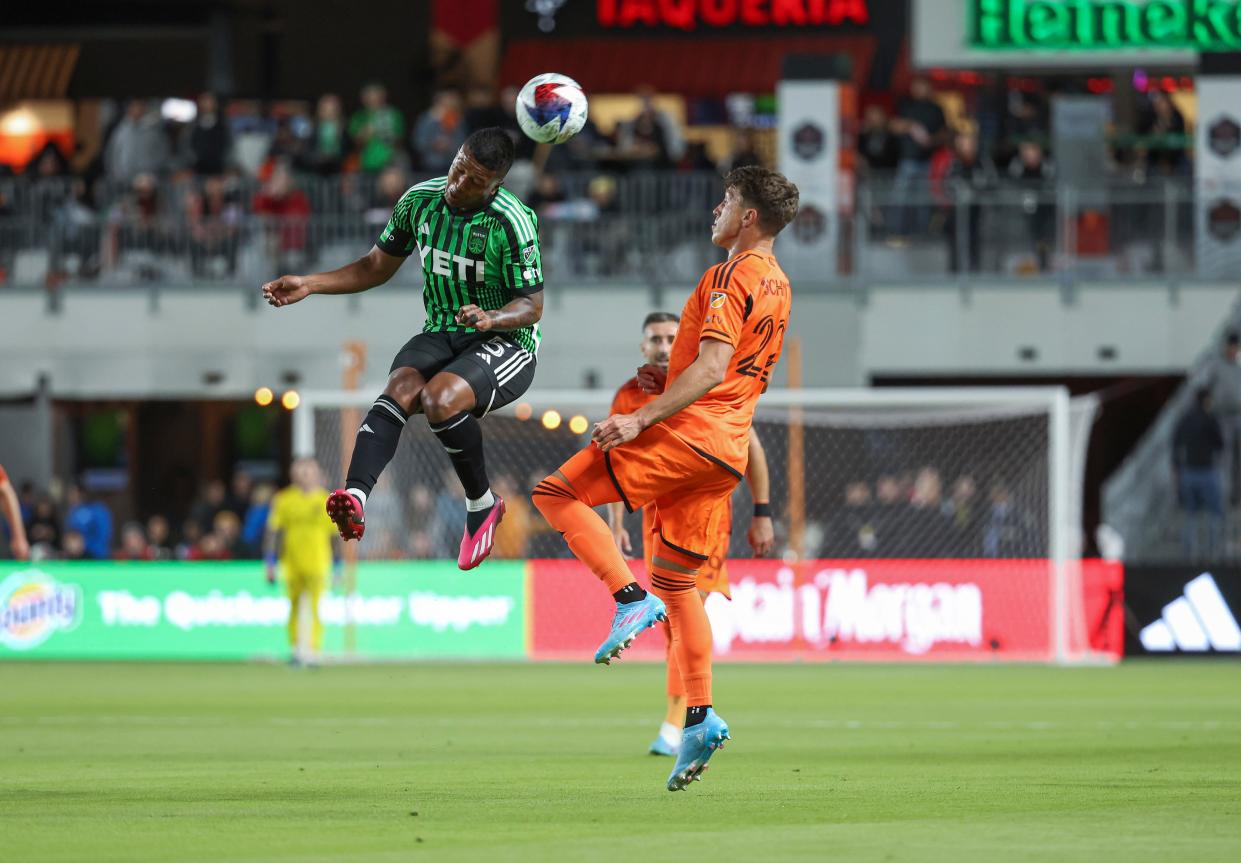 Austin FC midfielder Jhojan Valencia heads the ball as Houston Dynamo FC forward Tate Schmitt defends during El Tree's 2-0 loss Saturday night at Shell Energy Stadium in Houston. It was the end of a rough week for Austin FC.