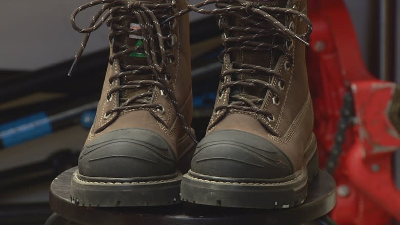 Alberta Finance Minister Joe Ceci donates work boots on pre-budget day