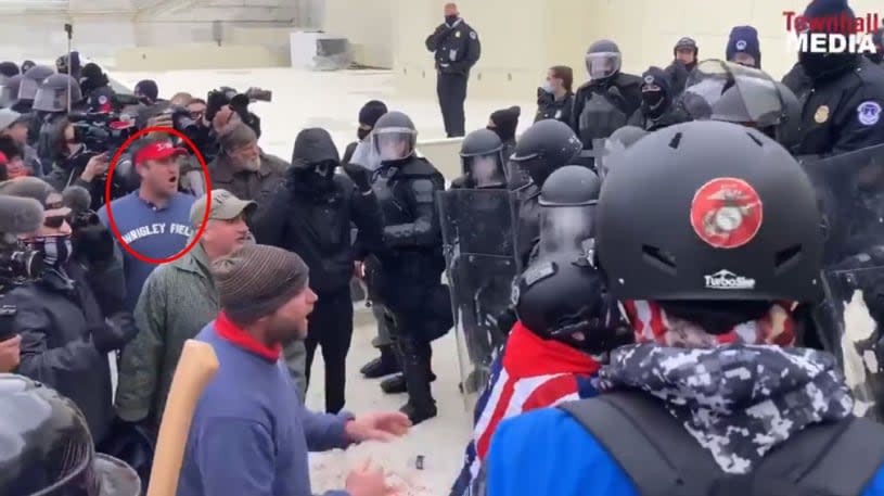 Screenshot from video showing Schubert (circled in red) approaching law enforcement officers.