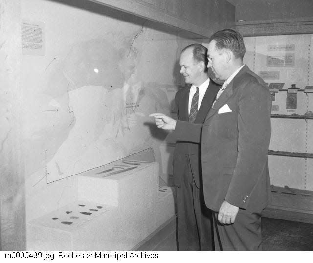 Rochester Museum of Arts and Sciences Director W. Stephen Thomas (left) and museum archeologist William A. Ritchie look at a map of New York state in the Native American collection. The institution was renamed the Rochester Museum and Science Center in 1968.