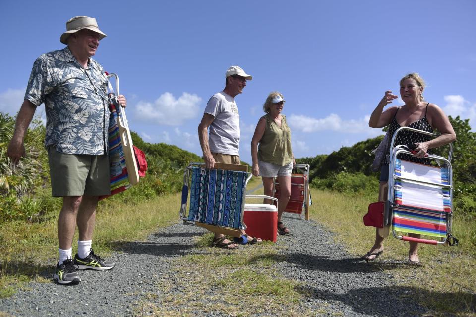 This Jan. 13, 2017 photo shows Vieques resident, Ohio retiree Thomas Toaddy, second from left, with his wife and friends near Ferro Port lighthouse where they spent the afternoon at Verdiales Key point on the south coast of Vieques island, Puerto Rico. Tourism has been growing in Vieques, which offers horseback riding, snorkeling adventures and trips to a popular bioluminescent bay, one of only a handful in the world. (AP Photo/Carlos Giusti)