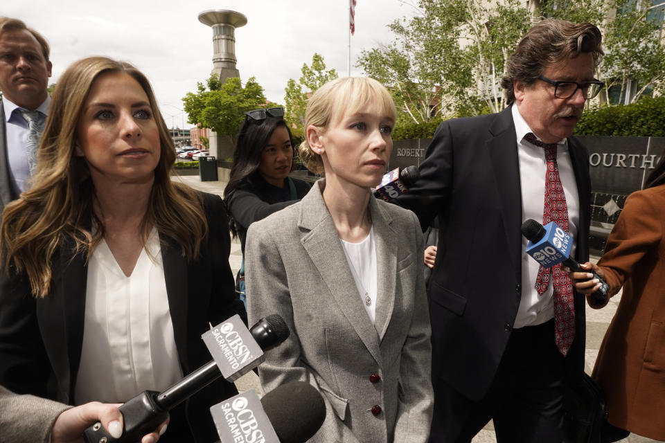 FILE - Sherri Papini of Redding leaves the federal courthouse accompanied by her attorney, William Portanova, right, in Sacramento, Calif., April 13, 2022. During a virtual hearing Papini accepted a plea bargain with prosecutors and pleaded guilty, Monday, April 18, 2022, to a single count of mail fraud and one count of making false statements. She will be sentenced on July 11, 2022. (AP Photo/Rich Pedroncelli, File)