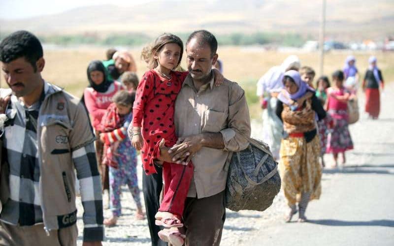 Yazidis fleeing an Isil advance on Sinjar Mountain