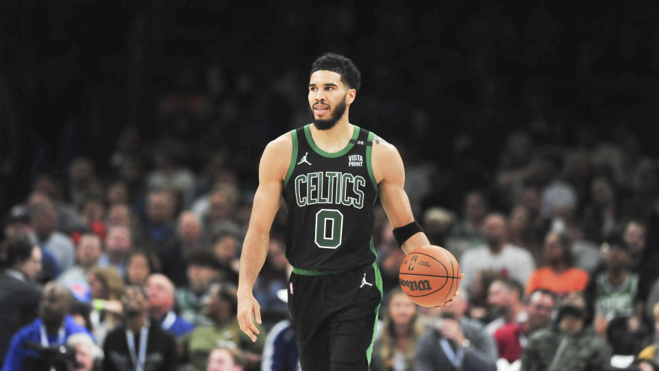 Boston Celtics forward Jayson Tatum pushes down the court in the second half of an NBA basketball game against the Oklahoma City Thunder, Monday, March 21, 2022, in Oklahoma City. (AP Photo/Kyle Phillips)