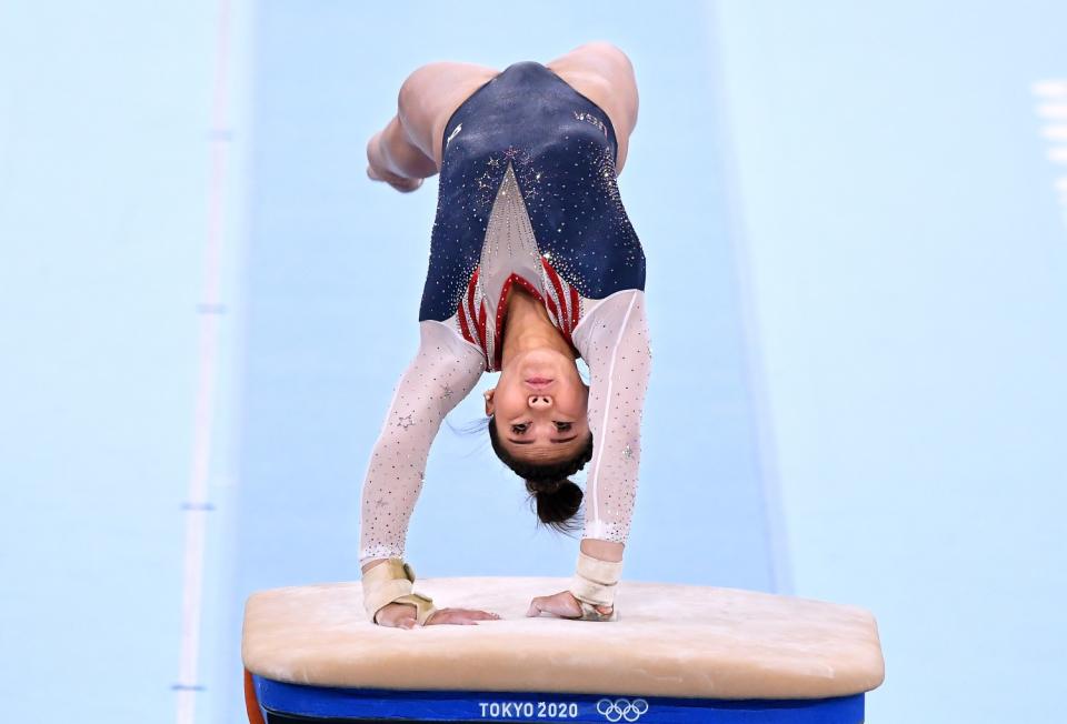 Sunisa Lee is shown upside down on the vault.