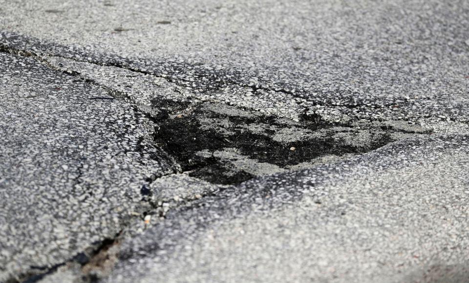 A patched pothole on Washington Street, Tuesday, April 12, 2022, in Manitowoc, Wis. There are plans to rebuild the well-traveled road.