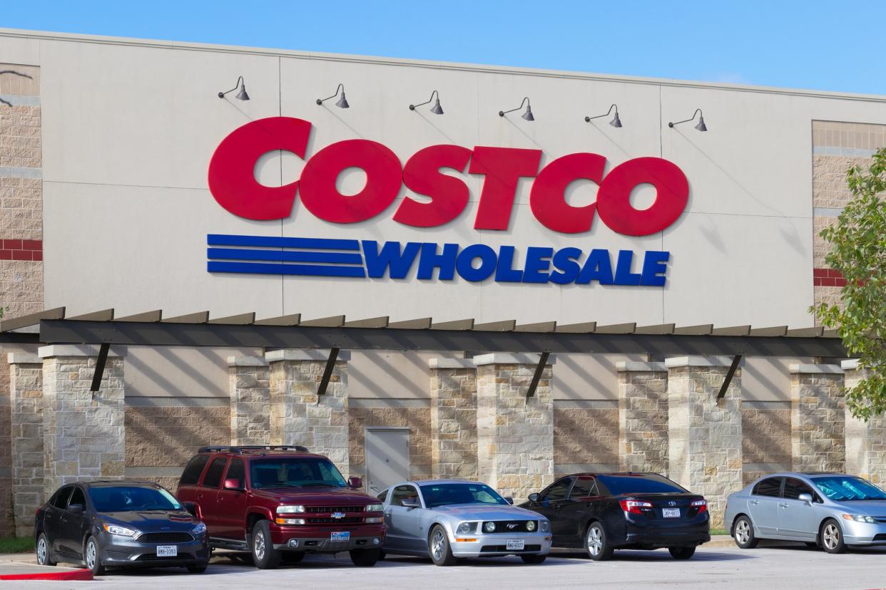 row of vehicles under the Costco Wholesale sign