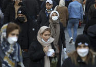 People visit the Grand Bazaar of Tehran, Iran, Saturday, Jan. 22, 2022. After successive virus waves pummeled the country for nearly two years, belated mass vaccination under a new, hard-line president has, for a brief moment, left the stricken nation with a feeling of apparent safety. (AP Photo/Vahid Salemi)