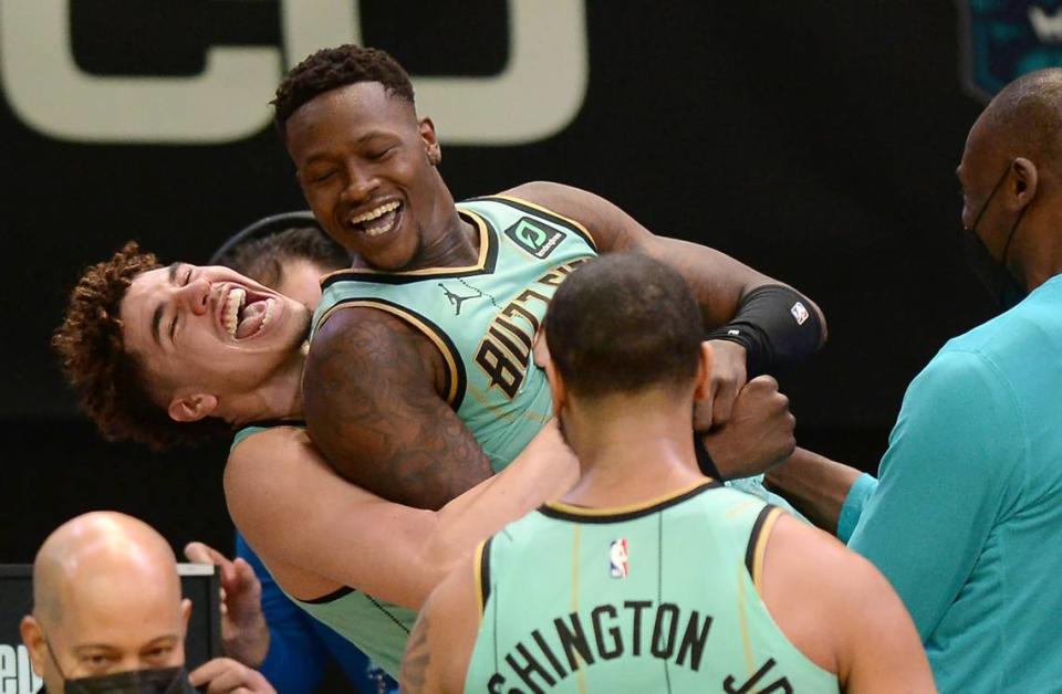 Charlotte Hornets guard Terry Rozier, center, is lifted up in the air by guard LaMelo Ball, left, as they celebrate Rozier’s game-winning basket against the Golden State Warriors on Feb. 20th.