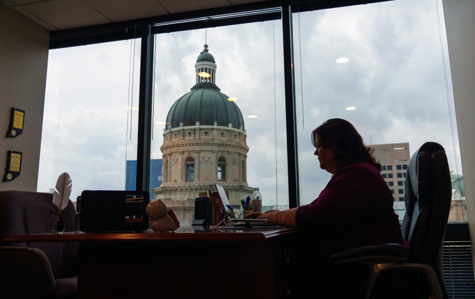 Niki Kelly, editor of Indiana Capital Chronicle, looks through staff stories Wednesday, Aug. 9, 2023, from her office overlooking the Indiana Statehouse. Kelly has covered five Governors over her 25-year span as a statehouse news reporter and editor.