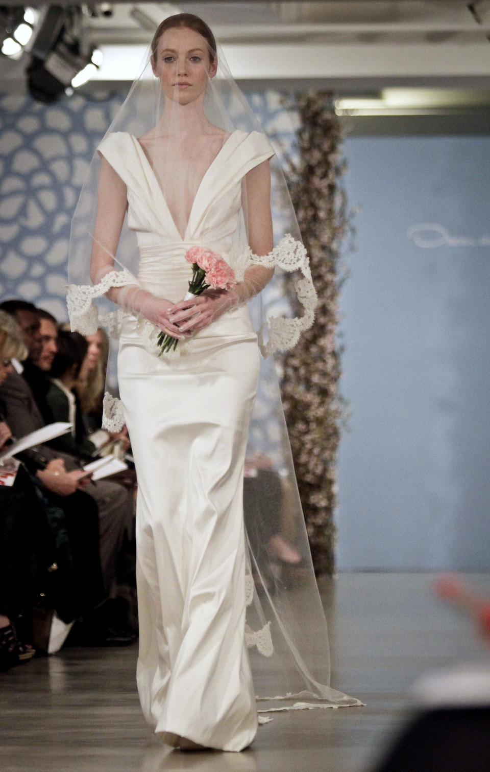 A model presents a bridal fashion creation from the Oscar de la Renta collection, in New York, Monday, April 22, 2013. (AP Photo/Bebeto Matthews)