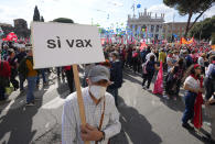 A man holds up a banner reading in Italian "Yes vax" as he takes part in a march organized by Italy's main labor unions, in Rome's St. John Lateran square, Saturday, Oct. 16, 2021. The march was called a week after protesters, armed with sticks and metal bars, smashed their way into the headquarters of CGIL, a left-leaning union, and trashed its office, during a demonstration to protest a government rule requiring COVID-19 vaccines or negative tests for workers to enter their offices. (AP Photo/Andrew Medichini)