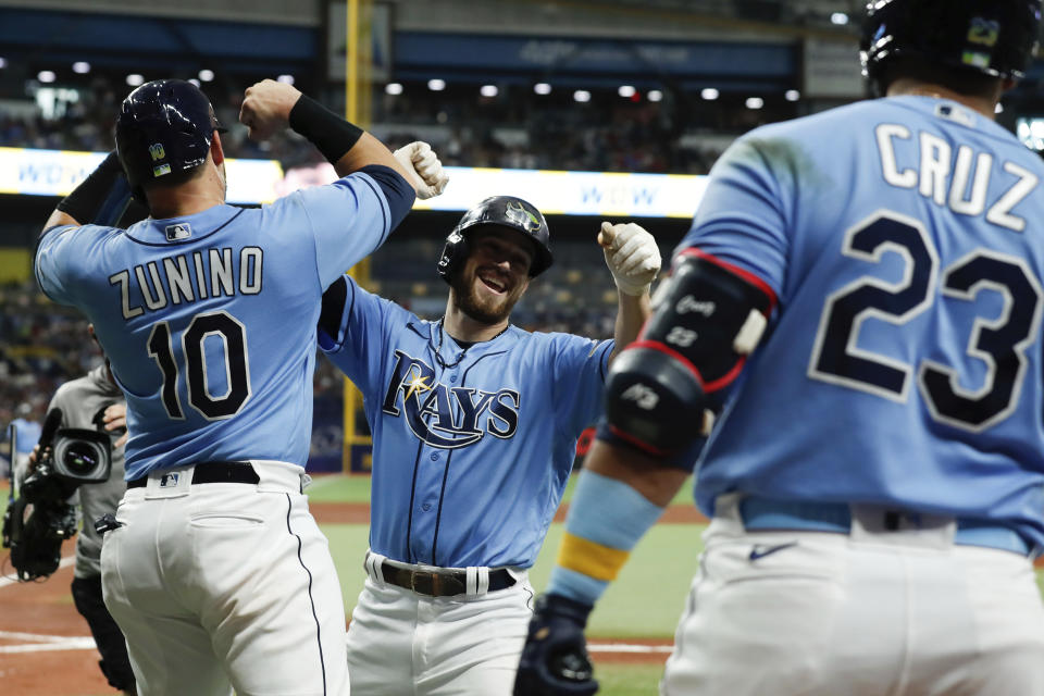 Tampa Bay Rays' Brandon Lowe celebrates with teammate Mike Zunino (10) after hitting a two-run home run against the Boston Red Sox during the third inning of a baseball game, Sunday, Aug. 1, 2021, in St. Petersburg, Fla. (AP Photo/Scott Audette)