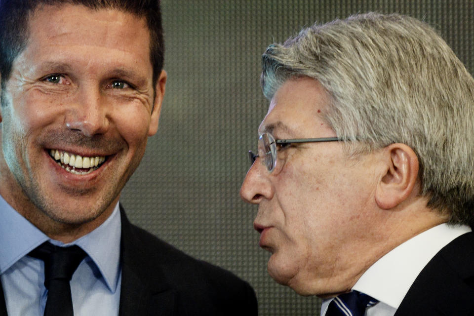 Atletico Madrid coach Diego Simeone, left, smiles while Atletico de Madrid president Enrique Cerezo speaks with him after a press conference at the Vicente Calderon stadium in Madrid, Spain, Tuesday, March 24, 2015. The former Argentina and Atletico midfielder, who took over as coach in December 2011, has renewed his contract with the Spanish champions for another five seasons, keeping him at the club until 2020. (AP Photo/Daniel Ochoa de Olza)